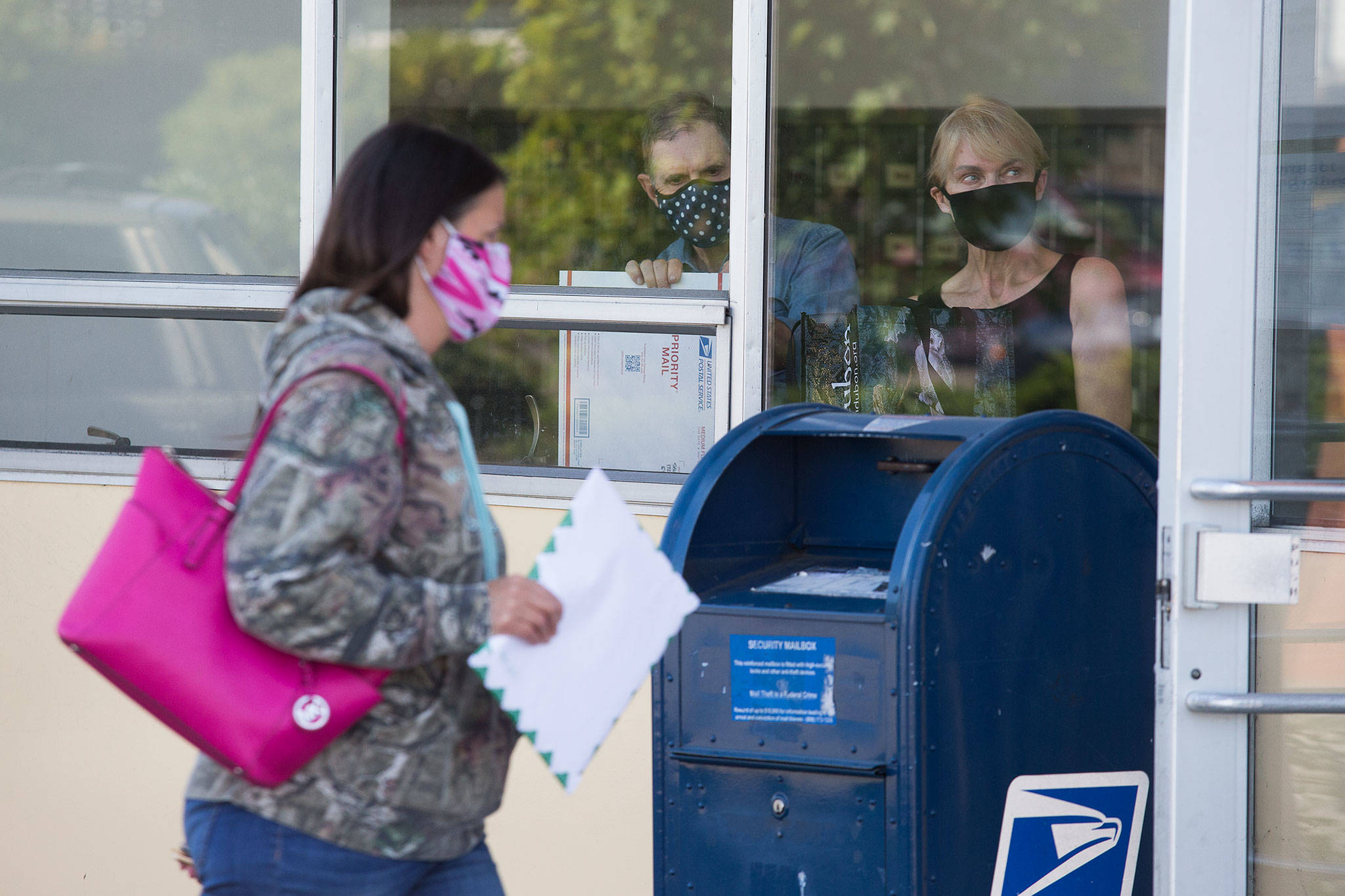Customers at the U.S. Post Office on Hoyt Avenue in Everett on Tuesday. (Andy Bronson / The Herald)