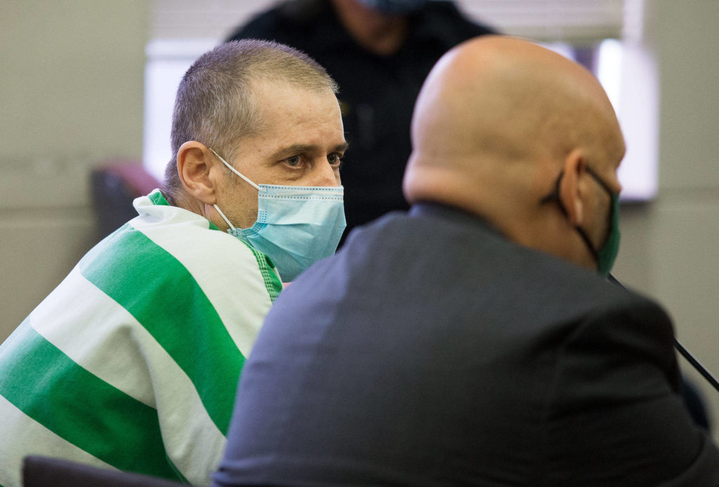 Alan Edward Dean stares at defense attorney Jon Scott during court proceedings at Snohomish County Courthouse on Tuesday. Dean, who has been accused of killing a 15-year-old girl in the early 1990s, has been ordered to undergo a mental health evaluation at Western State Hospital, after he refused to cooperate during two court hearings. (Andy Bronson / The Herald)
