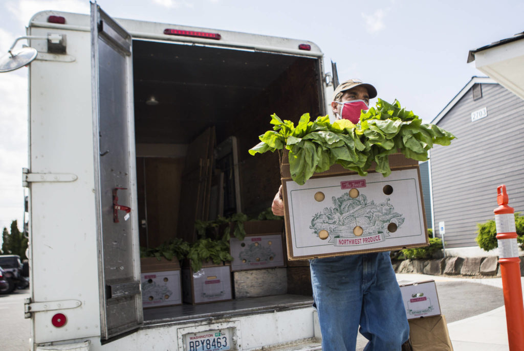 Vince Caruso of Caruso Farm in Snohomish unloads produce in Everett. (Olivia Vanni / The Herald) 
