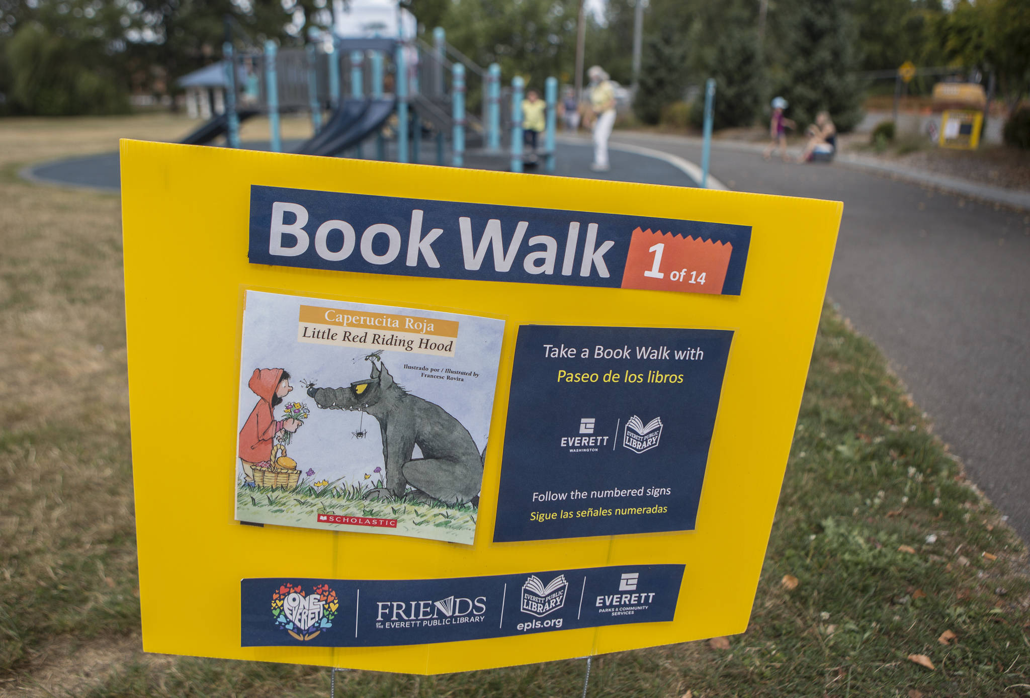 One of 14 book walk signs along Silver Lake Trail at Hauge Homestead Park in Everett. Parents can read the story aloud to their children as they stroll along. (Olivia Vanni / The Herald)