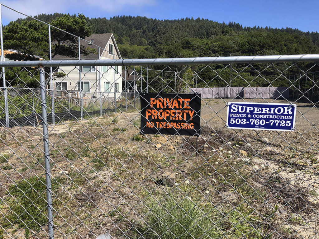 Facebook’s cable landing site is seen on a residential lot located within the high fence at the tiny village of Tierra del Mar, Oregon, on Aug. 17. (AP Photo/Andrew Selsky)
