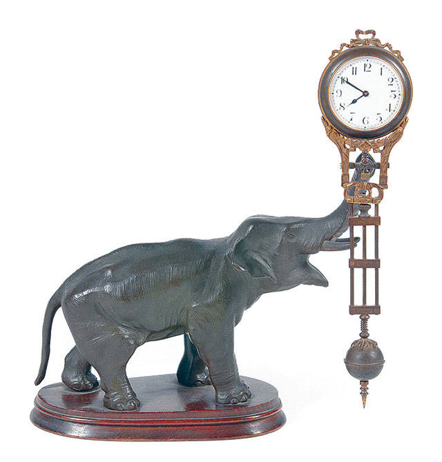 This elephant is swinging the clock, but there doesn’t seem to be anything making it move. That is why it is known as a swinger or mystery clock. It is 11 inches tall. (Cowles Syndicate Inc.)