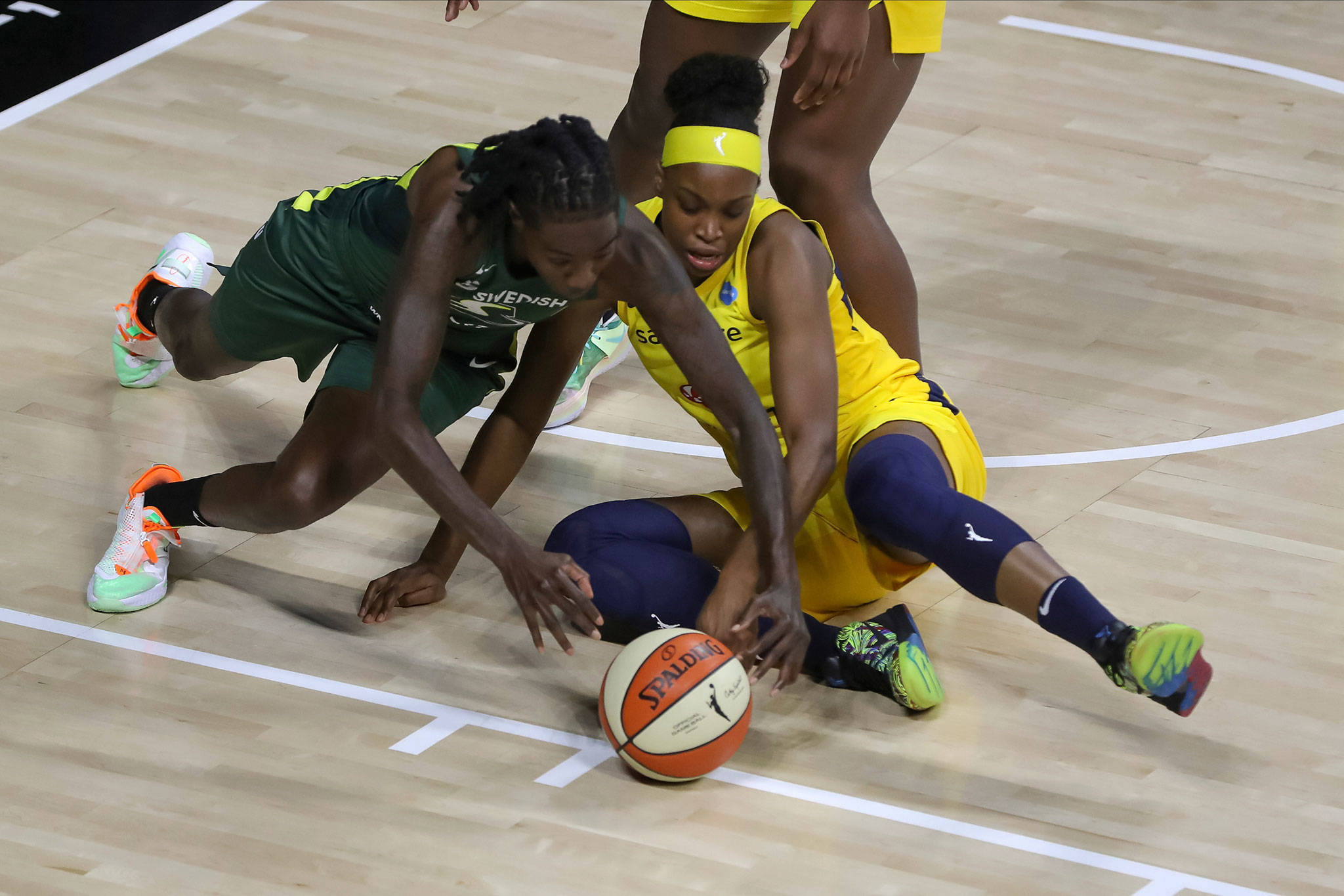 The Storm’s Natasha Howard (left) battles the Fever’s Kennedy Burke for the ball during the first half of a WNBA game Aug. 20, 2020, in Bradenton, Fla. (AP Photo/Mike Carlson)