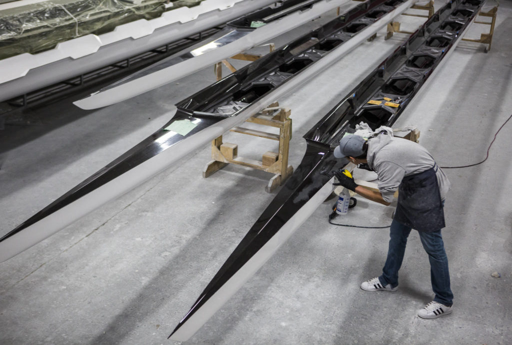 The outside of a racing shell is sanded. (Olivia Vanni / The Herald) 
