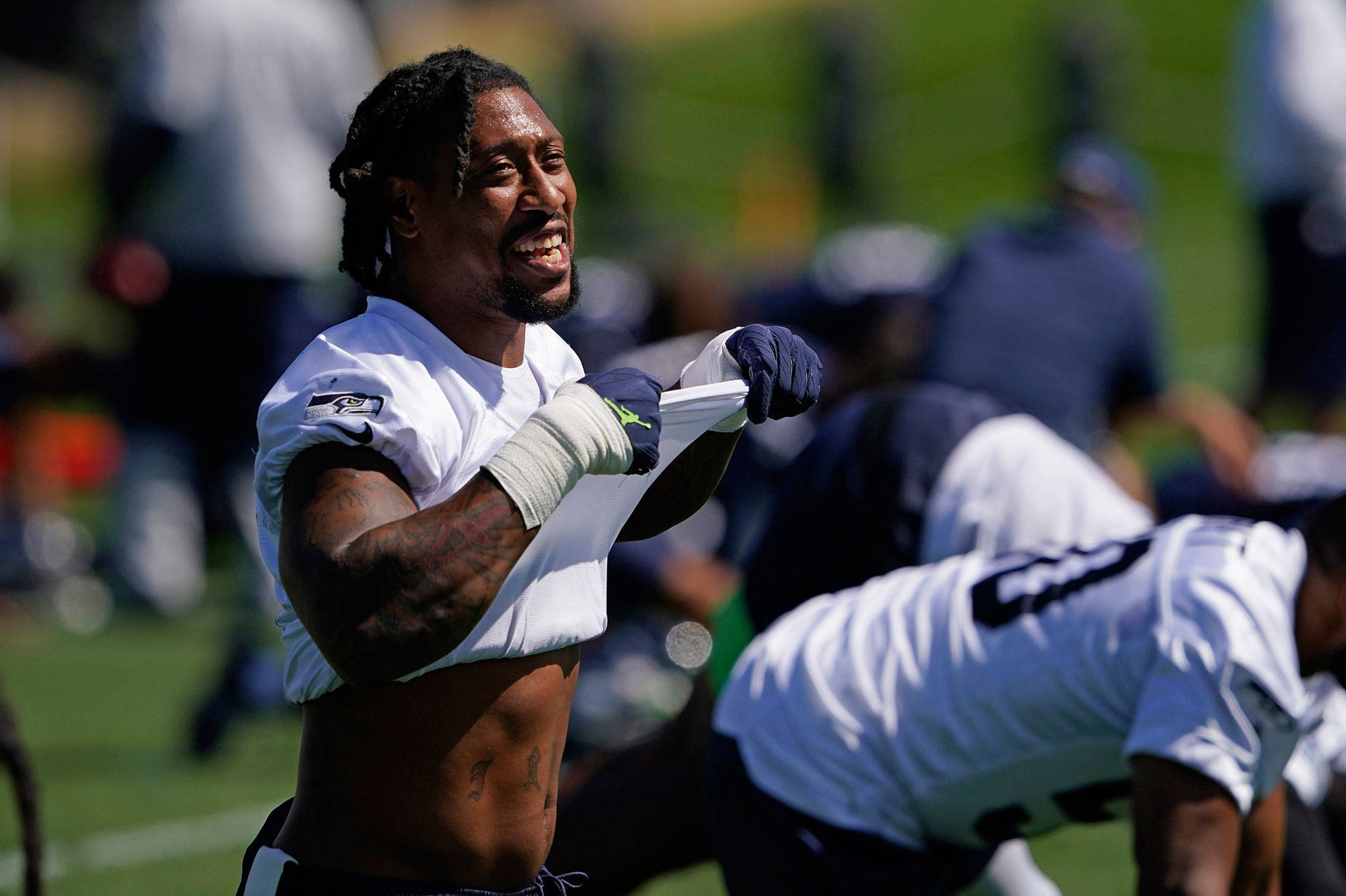 Seahawks linebacker Bruce Irvin stretches before practice on Aug. 24, 2020, at the Virginia Mason Athletic Center in Renton. (AP Photo/Ted S. Warren)