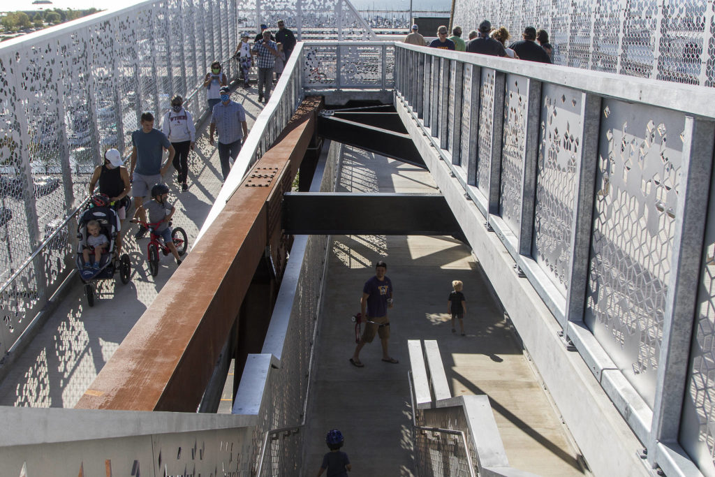 While most people walk down the ramp, a few take the stairs as the Grand Avenue Park Bridge opens for public use Wednesday in Everett. (Andy Bronson / The Herald)
