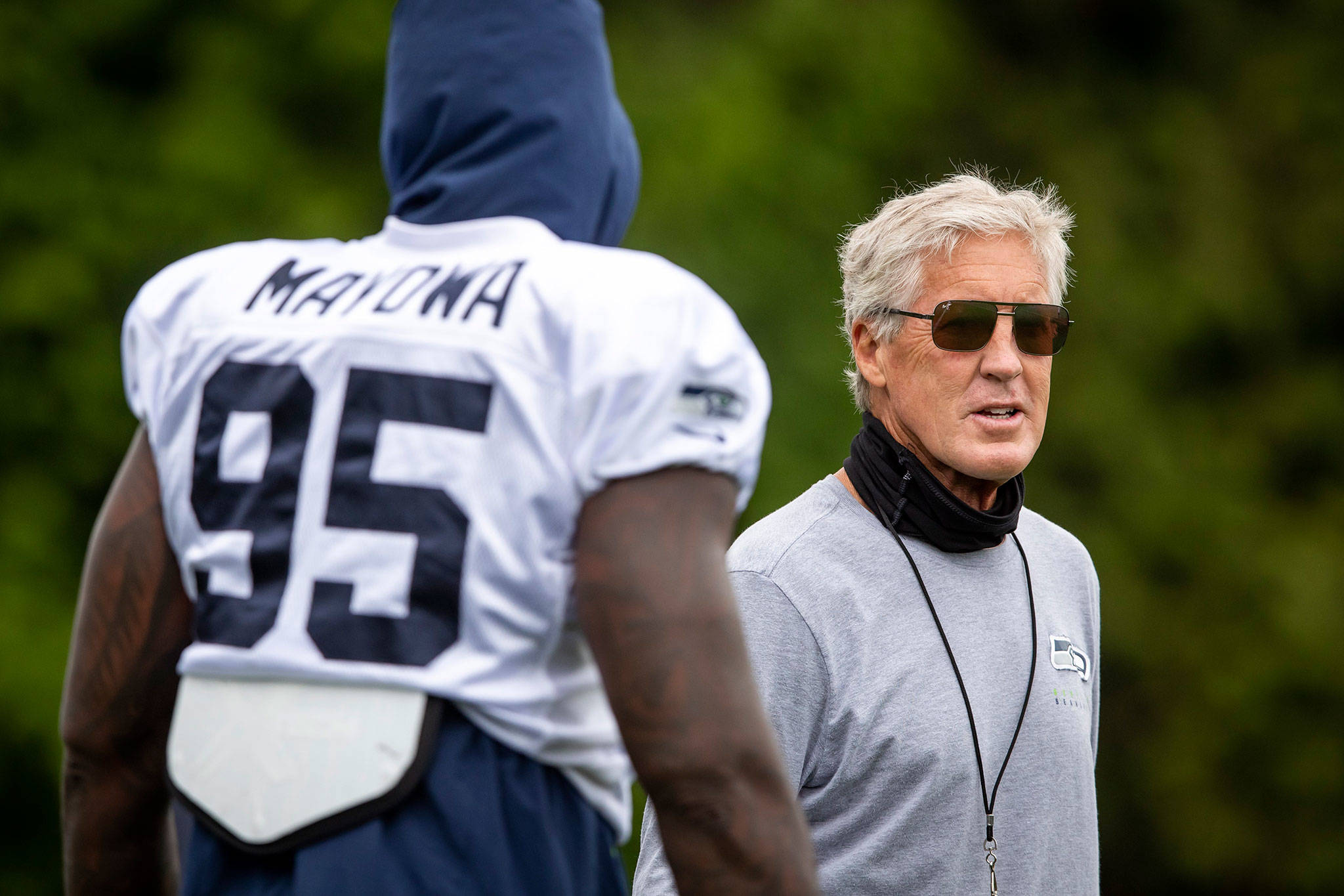 Seahawks head coach Pete Carroll talks with defensive end Benson Mayowa during training camp opn Aug. 21, 2020, in Renton. (Bettina Hansen/The Seattle Times via AP)