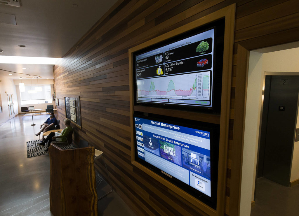 A monitor in the lobby at HopeWorks Station in Everett shows daily energy usage, cost and savings. (Andy Bronson / The Herald) 
