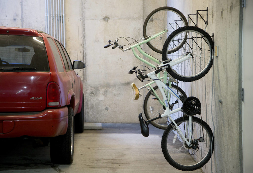 Bike racks line the walls of the parking garage at HopeWorks Station in Everett. (Andy Bronson / The Herald) 
