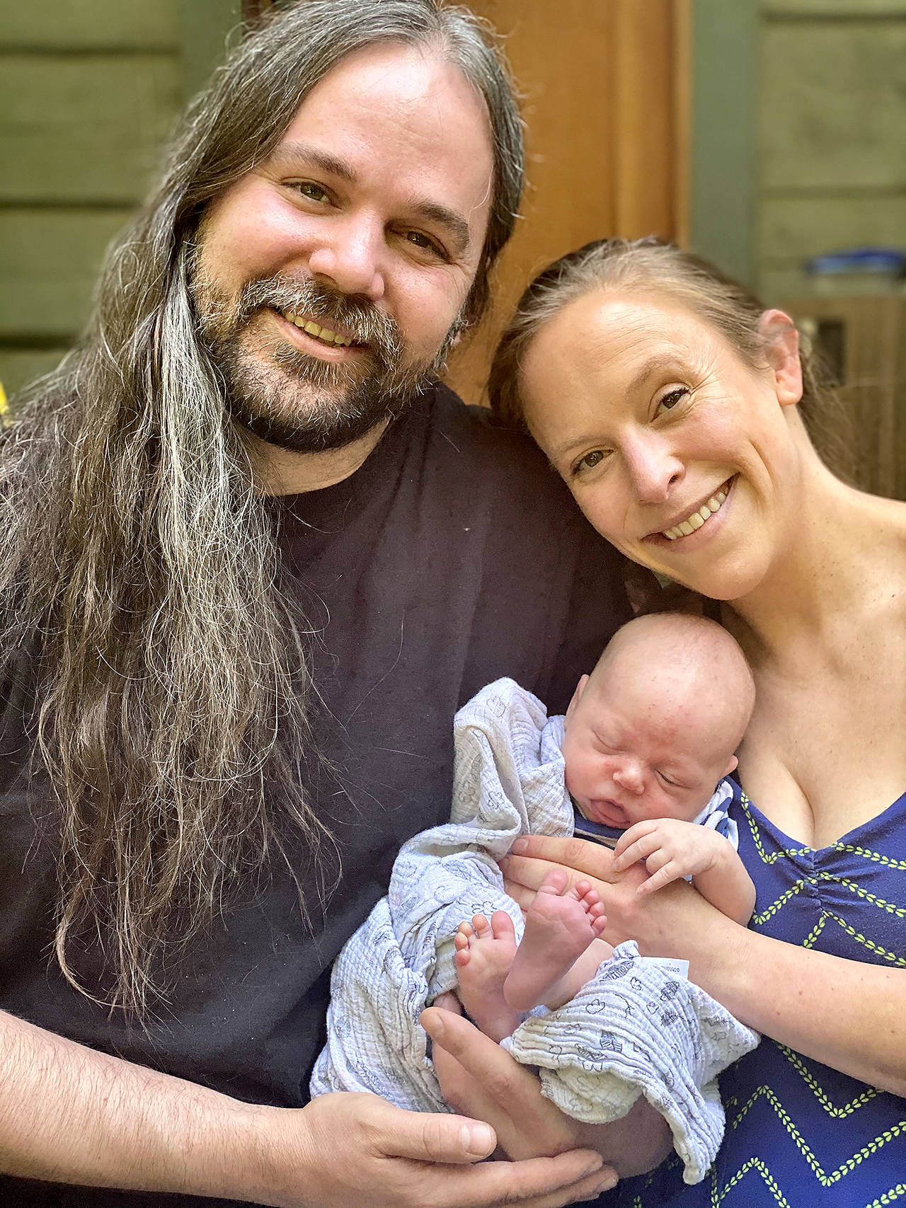 Charlotte Daphne-Celeste Buzard Simmons-Otness sleeps in the arms of her parents, Mark Buzard and Oriana Rose Crystal Anemone Simmons-Otness. The baby was born Aug. 19 in Everett. Her first three initials are CDC. (Andrea Brown / The Herald)