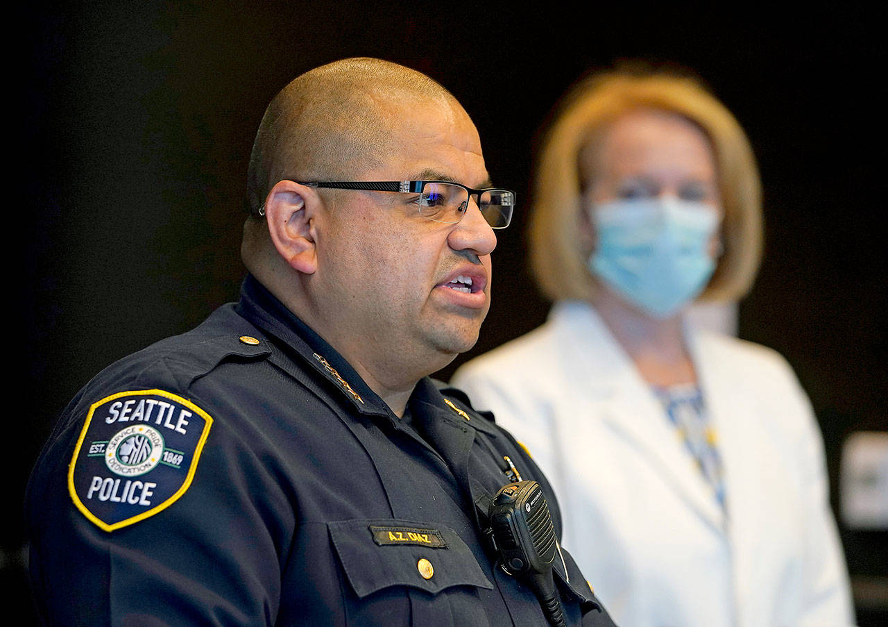 Interim Seattle Police Chief Adrian Diaz (left) addresses a news conference on Wednesday with Mayor Jenny Durkan about changes being made at the department. (AP Photo/Elaine Thompson)