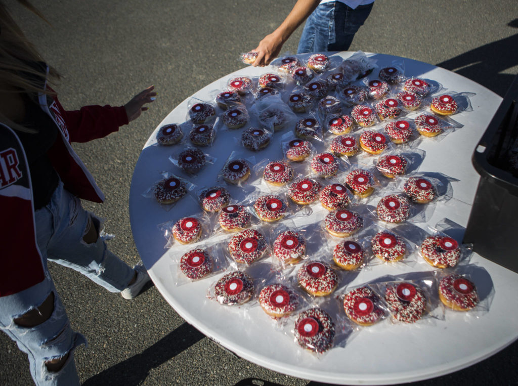 Individually wrapped donuts were handed out as Stanwood High School seniors drove through the campus on Thursday . (Olivia Vanni / The Herald) 
