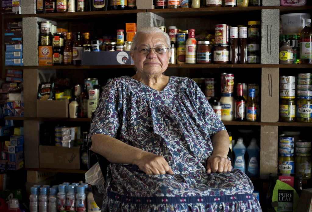 Leanne Aleia, 86, at her Mill Creek home, surrounded by only a fraction of the food she has collected for donation. (Olivia Vanni / The Herald)
