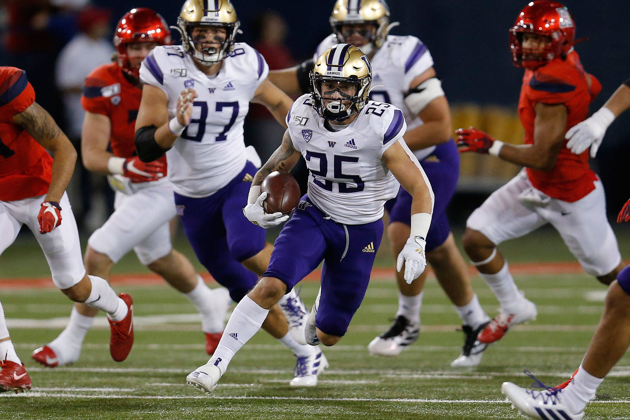 Washington running back Sean McGrew (25) carries the ball in the first half of a game against Arizona on Oct. 12, 2019, in Tucson, Ariz. (AP Photo/Rick Scuteri)