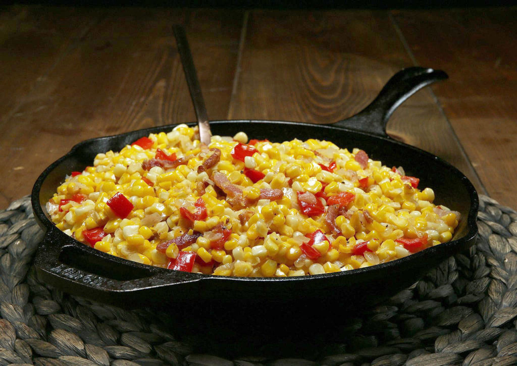 For maque choux, saute chopped onion and bell peppers in fat, then stir in the corn, garlic and bacon. Finish the dish with seasonings and a little cream. (Terrence Antonio James / Chicago Tribune)
