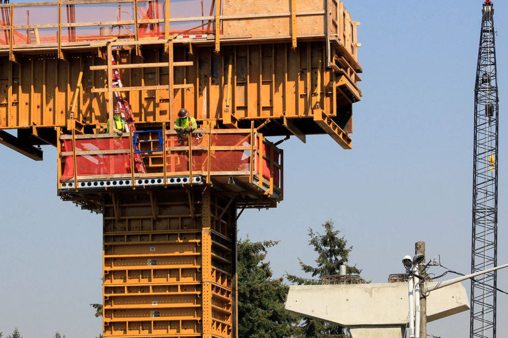 Construction workers make progress on a column for the light rail extension to Lynnwood on Wednesday. (Joey Thompson / The Herald)
