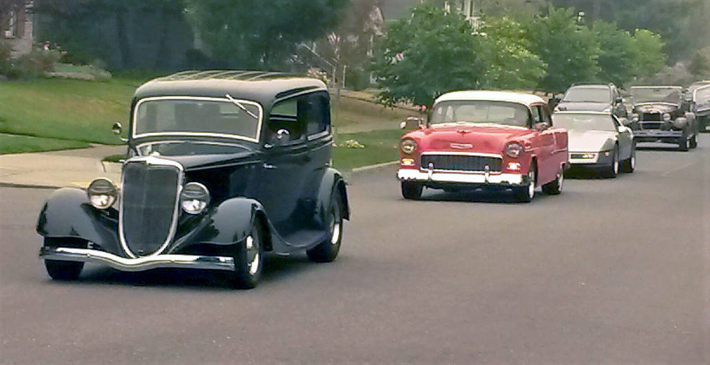 Vintage autos of many eras line Everett’s Rucker Avenue during an informal cruise event Saturday. (Julie Muhlstein / The Herald)
