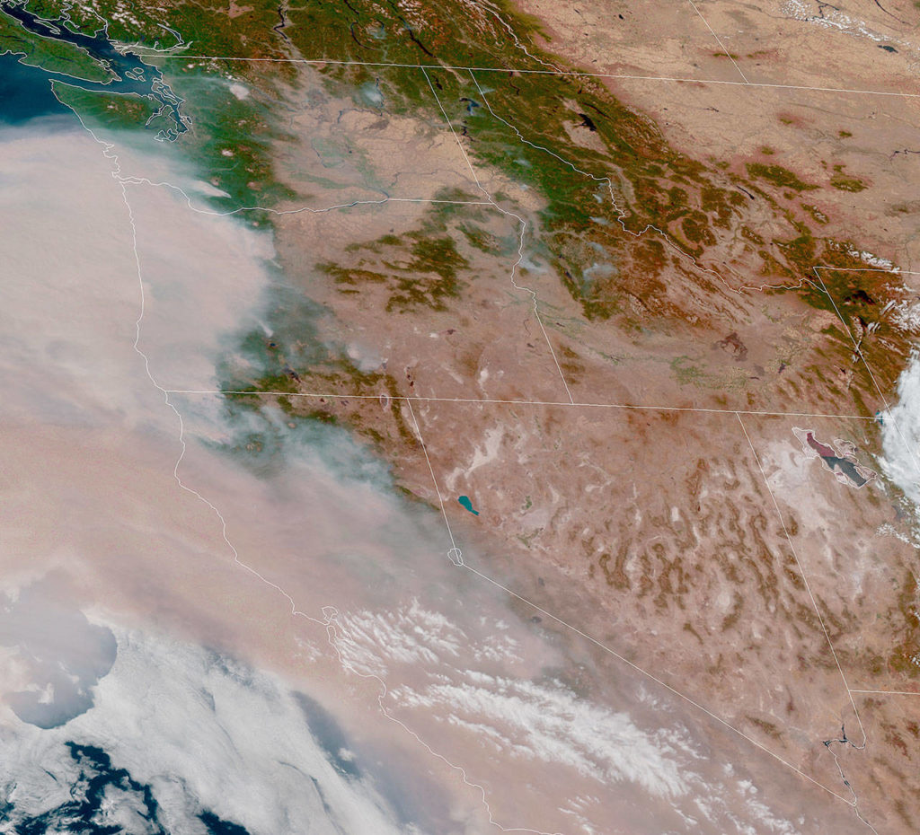 Smoke has inundated the West Coast and was forecast to move north to the Puget Sound region. This view from a weather satellite was taken Thursday afternoon. (National Oceanic and Atmospheric Administration) 
