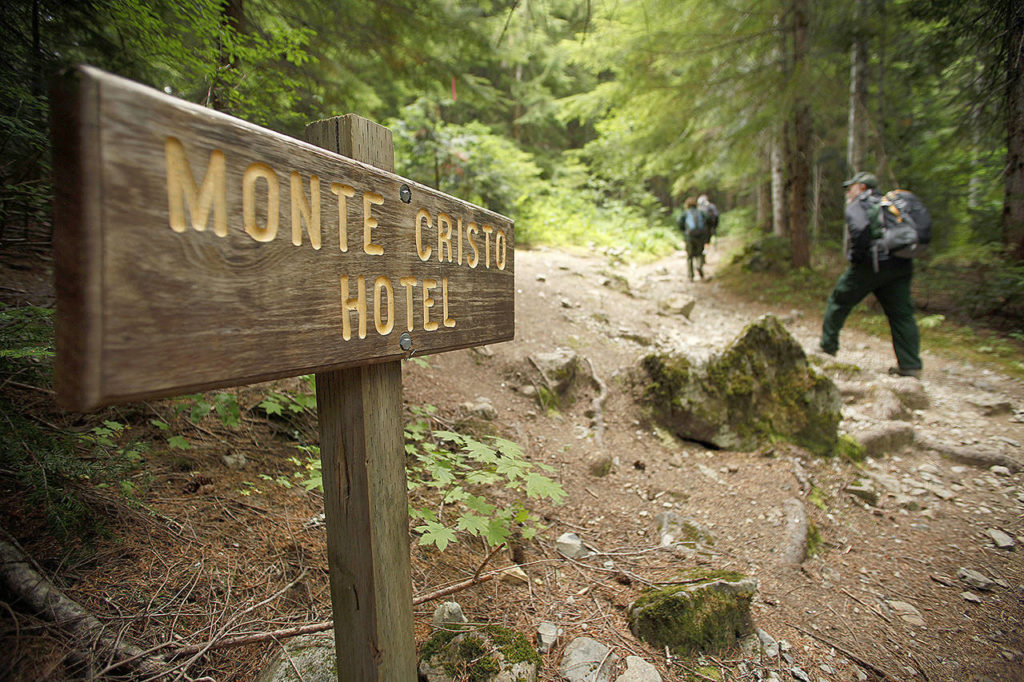 Darrington District Ranger Peter Forbes hikes past the former site of the Monte Cristo Hotel on Aug. 28, 2012, during a hike up the Monte Cristo trail. A federally mandated hazardous waste clean-up of leftover arsenic lost track of $300,000 spent by the state Department of Ecology. (Mark Mulligan / Herald file)

