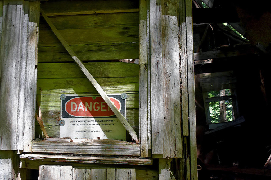 A sign warns of danger at the Monte Cristo townsite in 2018. (Caleb Hutton / Herald file)
