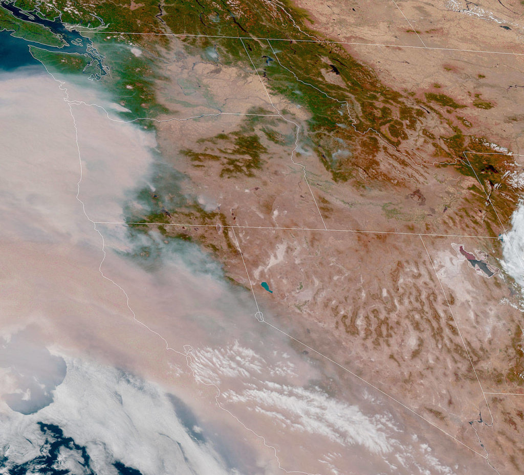Smoke has inundated the West Coast and was forecast to move north to the Puget Sound region. This view from a weather satellite was taken Thursday afternoon. (National Oceanic and Atmospheric Administration)
