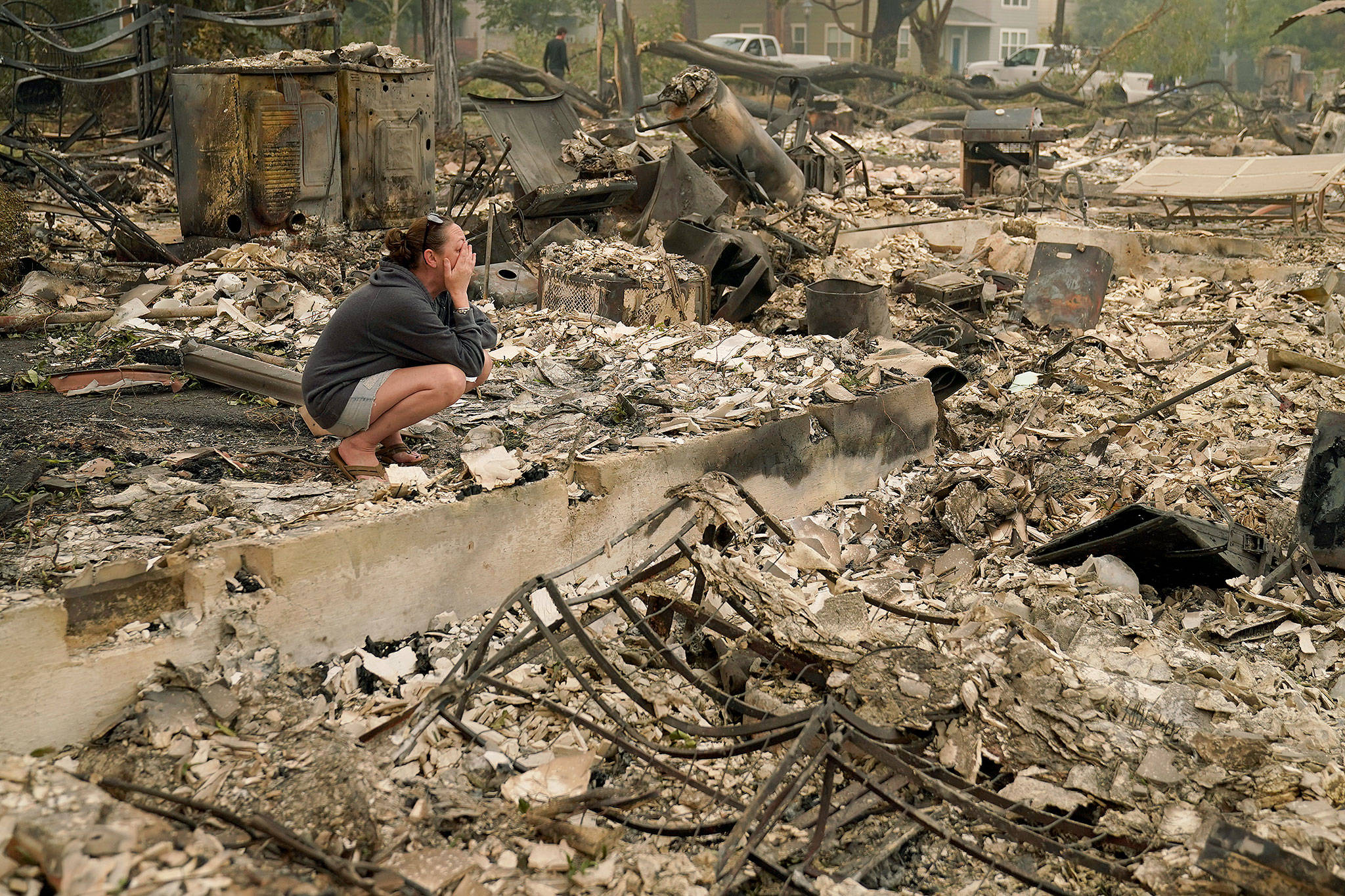 Desiree Pierce cries Friday as she visits her home, which was destroyed by the Almeda Fire in Talent, Oregon. “I just needed to see it, to get some closure,” said Pierce. (AP Photo/John Locher)