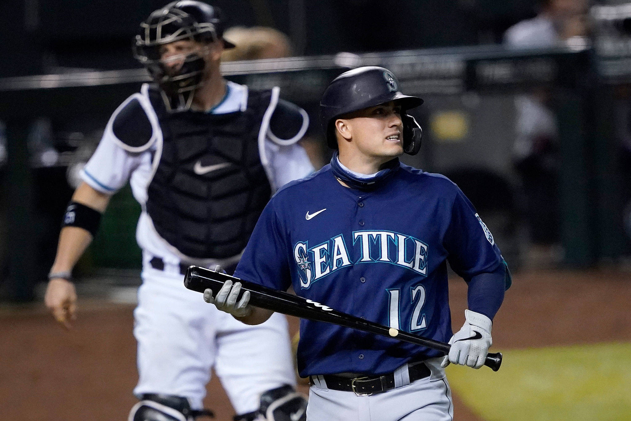 The Mariners’ Evan White (12) walks to the dugout after striking out during the ninth inning of a game against the Diamondbacks on Sept. 11, 2020, in Phoenix. (AP Photo/Matt York)