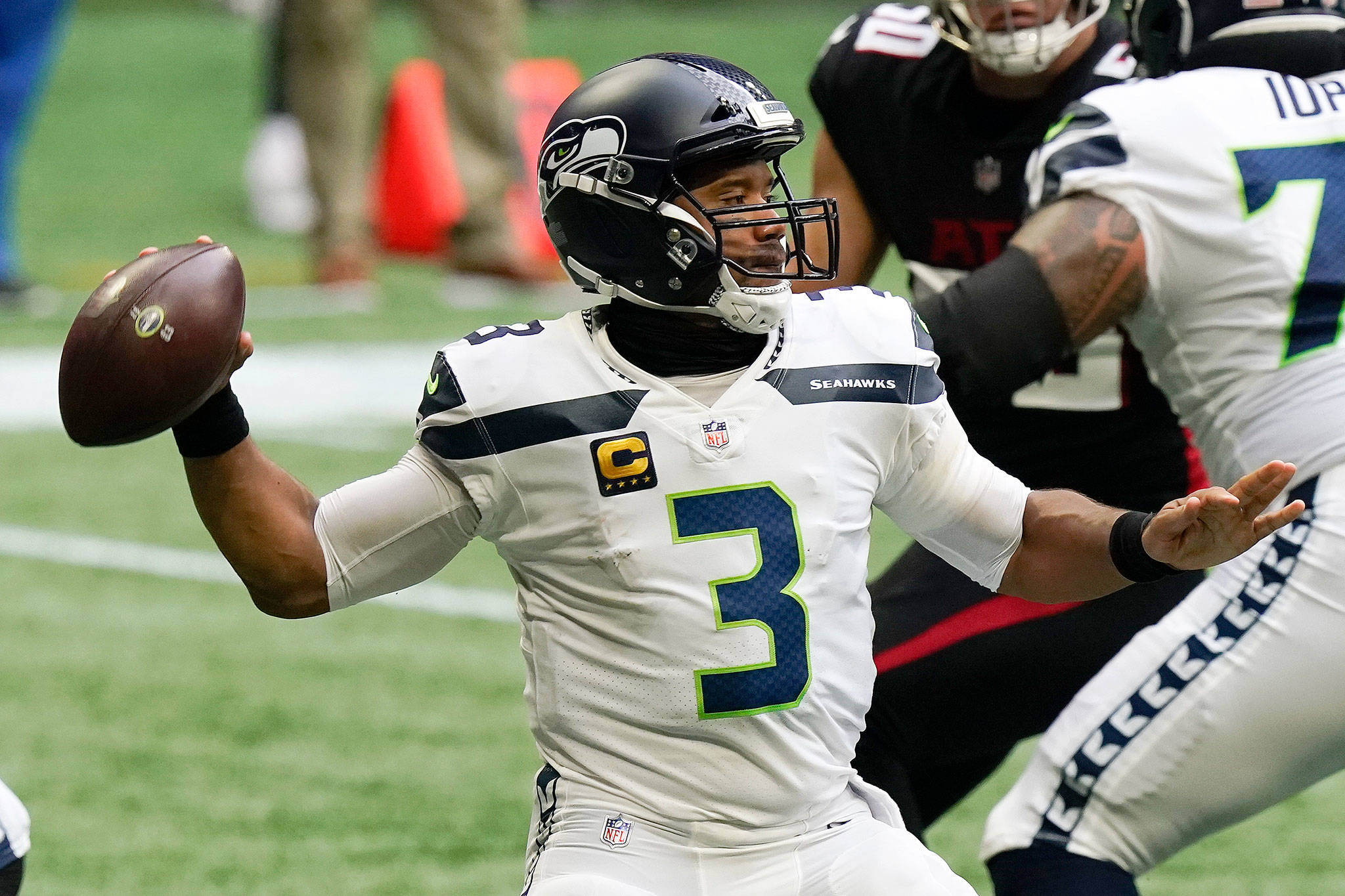 Seattle Seahawks quarterback Russell Wilson throws a pass in the first half against Atlanta on Sunday. He went an eye-popping 31 for 35 for the game. (Associated Press)