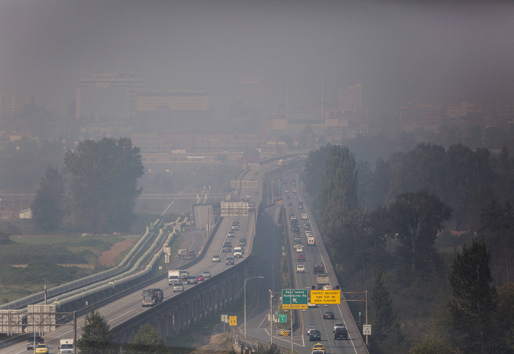 Cars make their way across US 2 between Lake Stevens and Everett as wildfire smoke makes downtown Everett barely visible on Friday, Sept. 11, 2020. (Olivia Vanni / The Herald)
