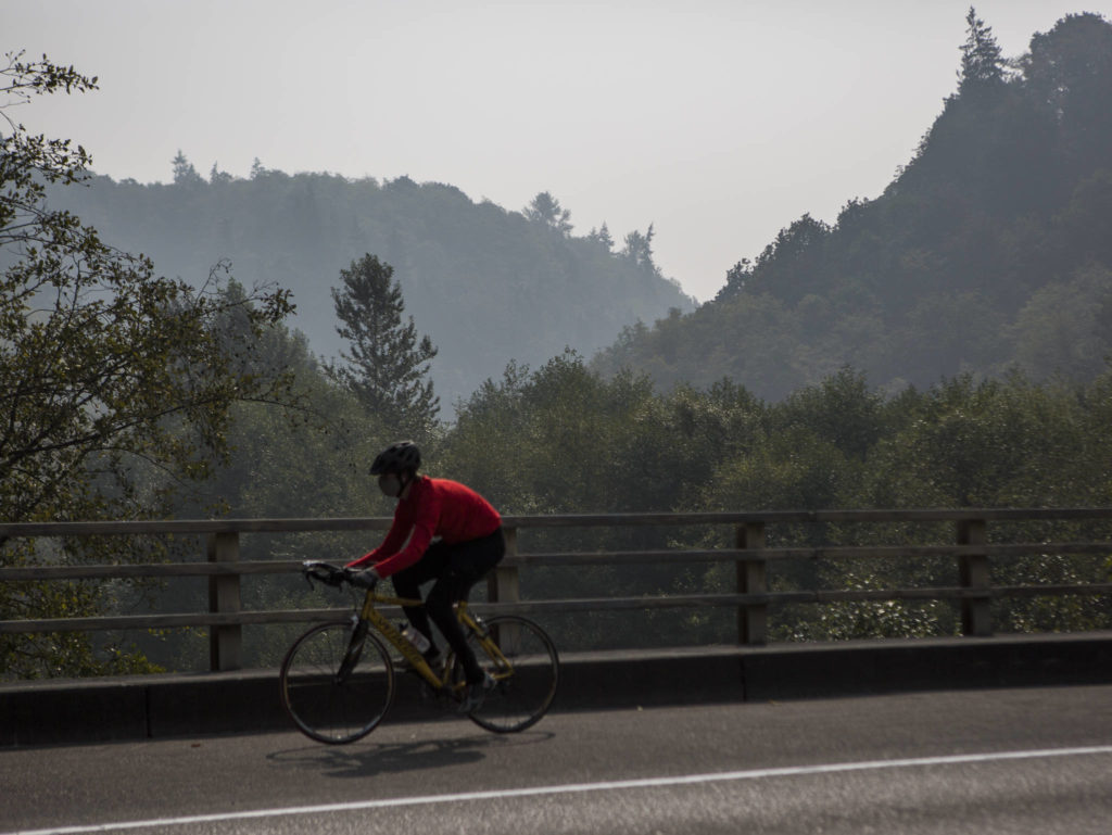 A biker rides along Mukilteo Boulevard through wildfire smoke on Friday, Sept. 11, 2020 in Mukilteo, Wa. (Olivia Vanni / The Herald)
