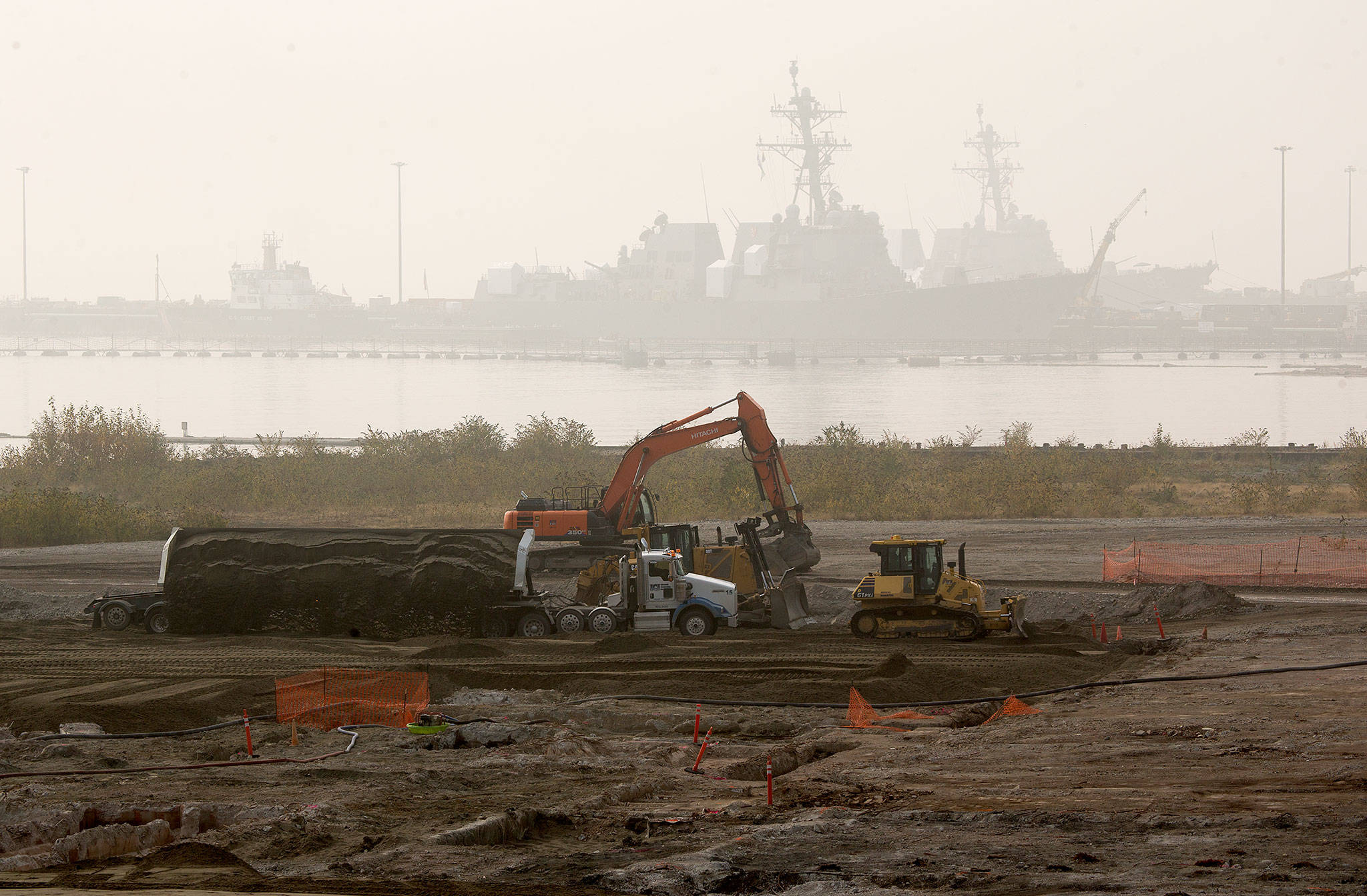 At the site of a former Kimberly-Clark paper and pulp mill, a side loader dumps dirt as crews work on Tuesday in Everett. The Port of Everett has won nearly $18 million in federal funding to help pay for the construction of a cargo terminal on the land. (Andy Bronson / The Herald)