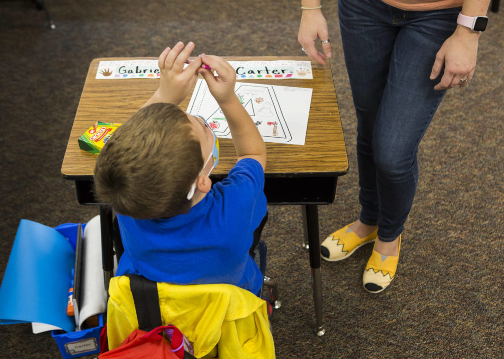 A kindergartener works on a worksheet during class on Thursday in Stanwood. (Olivia Vanni / The Herald) 
