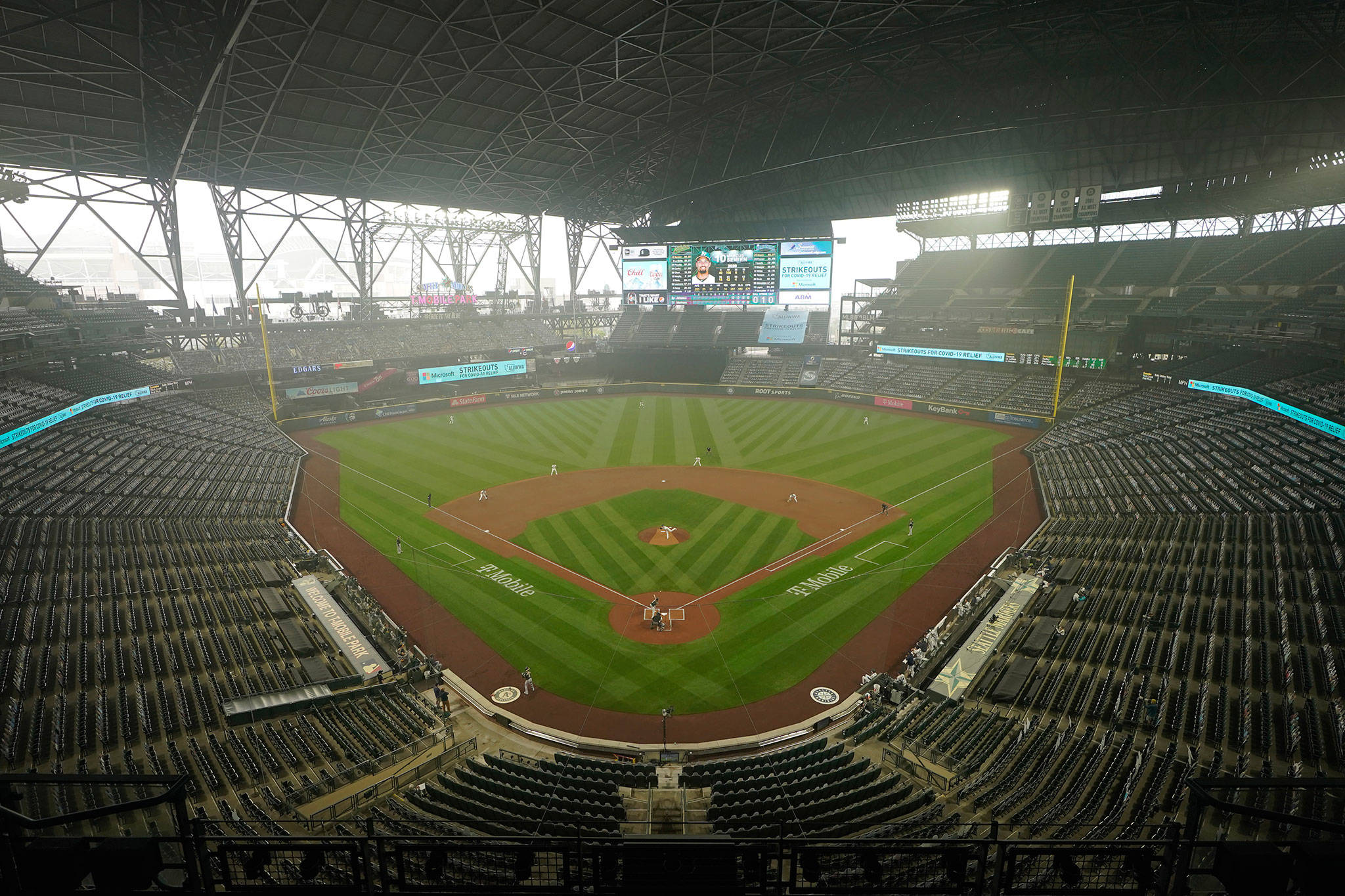 Smoke from wildfires fills the air at T-Mobile Park as the Mariners and the Athletics play with the roof extended during the first inning of the first baseball game of a doubleheader Sept. 14, 2020, in Seattle. (AP Photo/Ted S. Warren)