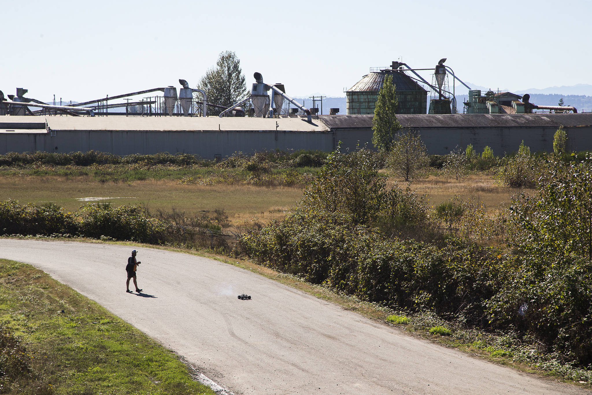 A man operates a radio-controlled car near the Bay Wood property on Monday in Everett. The Port of Everett is set to clean up the site, which lies along the northern end of West Marine Drive where the Snohomish River and Port Gardner meet. (Andy Bronson / The Herald)