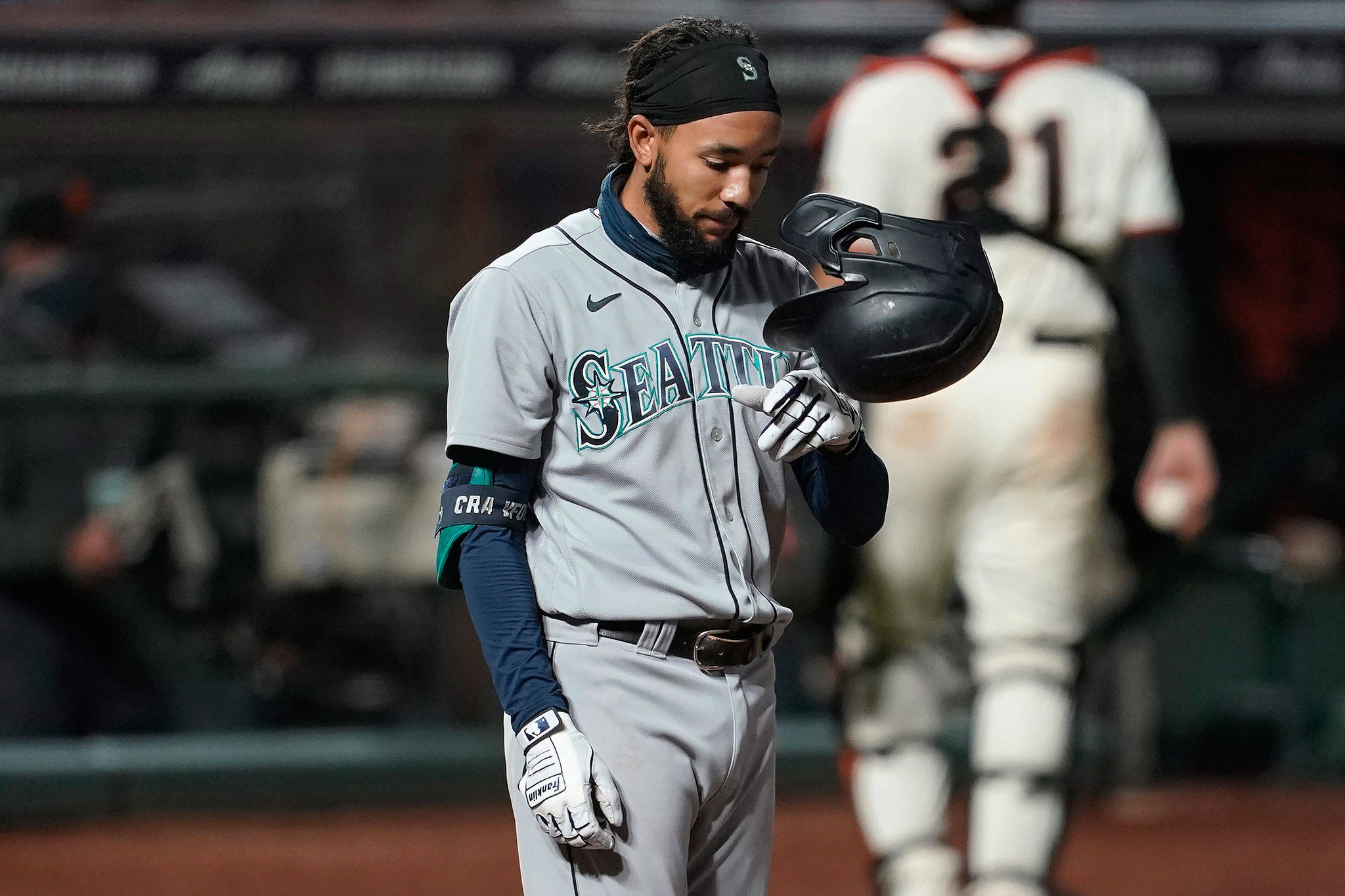 The Mariners’ J.P. Crawford tosses his helmet after striking out during the sixth inning of a game against the Giants on Sept. 16, 2020, in San Francisco. (AP Photo/Jeff Chiu)
