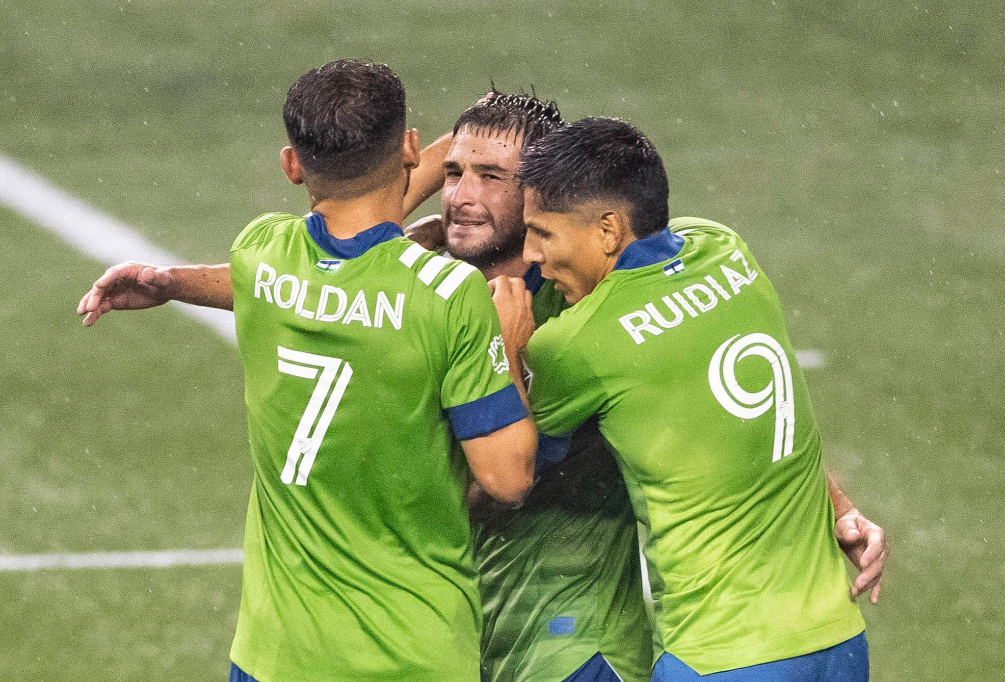 Sounders players gather around captain Nicolas Lodeiro (center) after he scored the second of two penalty kicks in the first half of an MLS match against Los Angeles FC on Sept. 18, 2020, in Seattle. (Dean Rutz/The Seattle Times via AP)