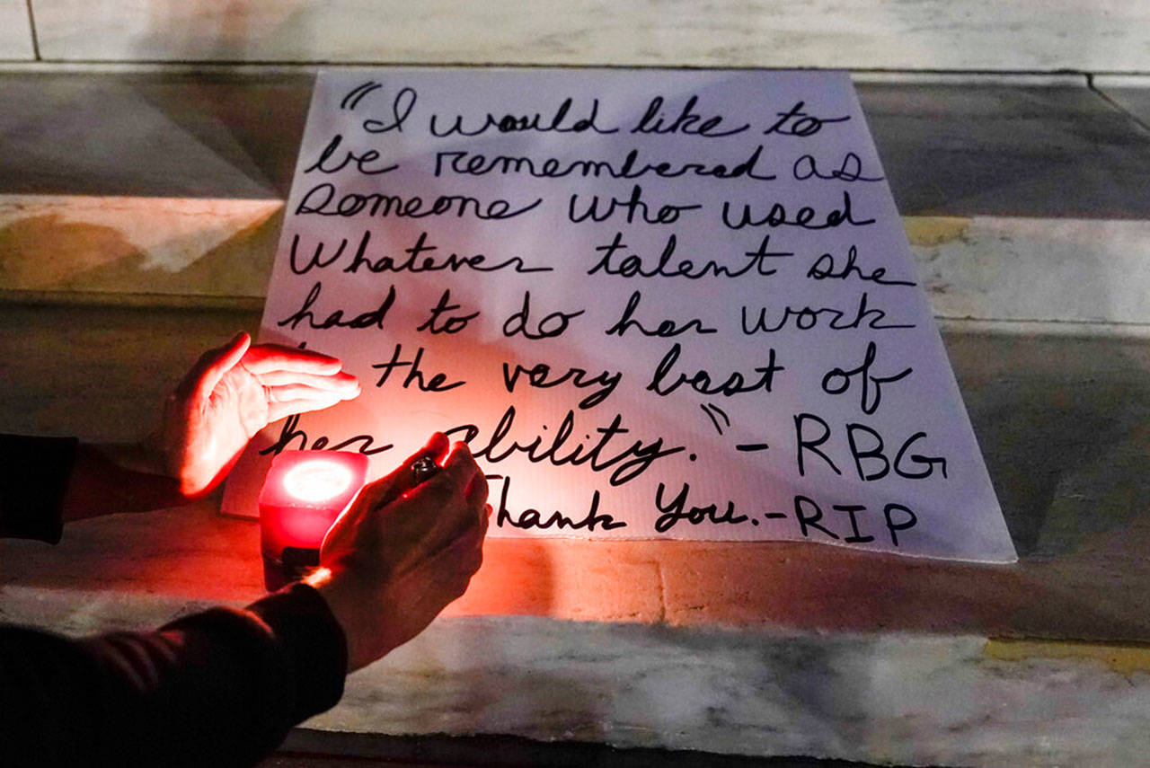 People light candies outside the Supreme Court Friday, Sept. 18, 2020, in Washington, after the Supreme Court announced that Supreme Court Justice Ruth Bader Ginsburg died of metastatic pancreatic cancer at age 87. (Alex Brandon / Associated Press)