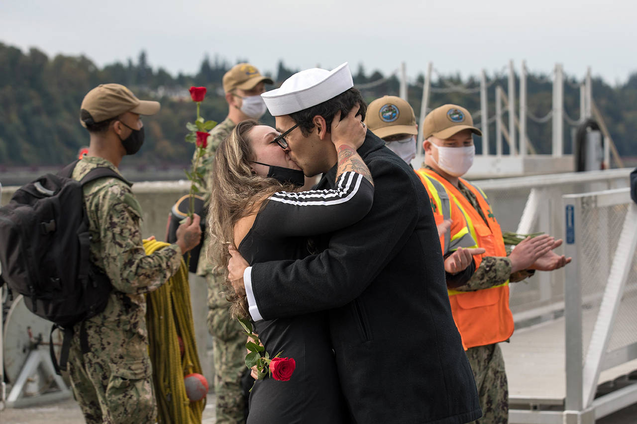 A sailor kisses his significant other after the USS Kidd arrives at Naval Station Everett Monday morning. (U.S. Navy photo by Mass Communication Specialist 3rd Class Ethan Soto/Released)