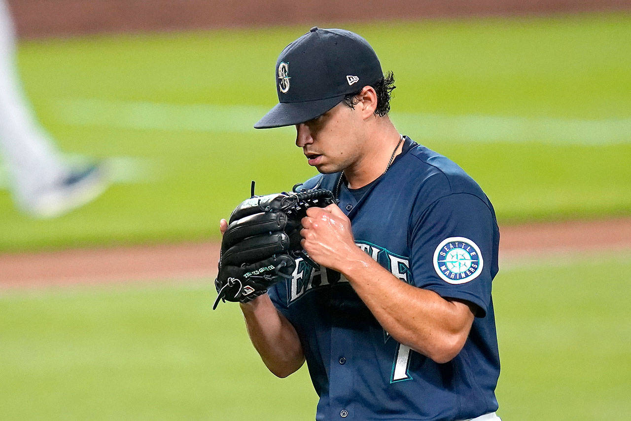 Seattle Mariners starting pitcher Marco Gonzales pounds his glove as he heads off the field in the sixth inning against the Astros on Monday. (Associated Press)