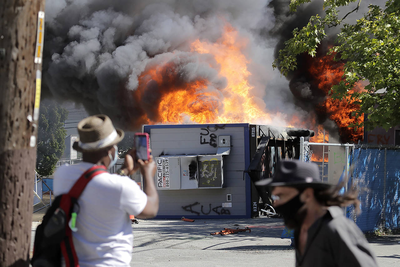 Construction buildings burn near the King County Juvenile Detention Center on July 25 in Seattle. (AP Photo/Ted S. Warren, file)