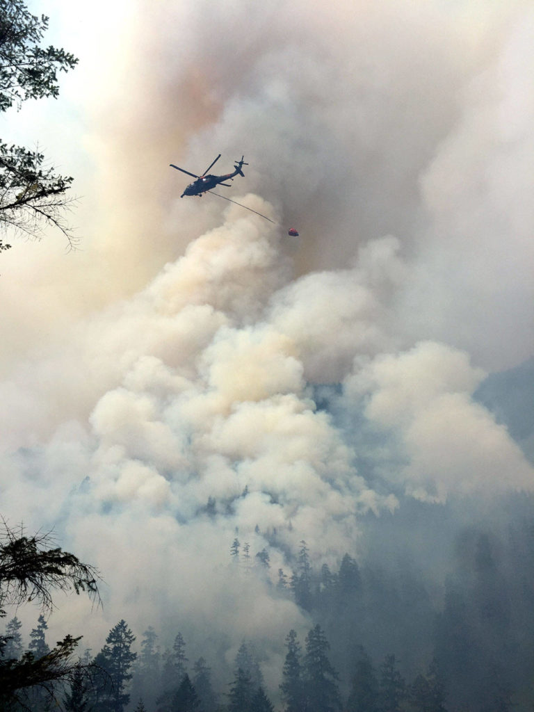 A National Guard helicopter douses the Maple Fire in 2018. (Washington Department of Natural Resources)
