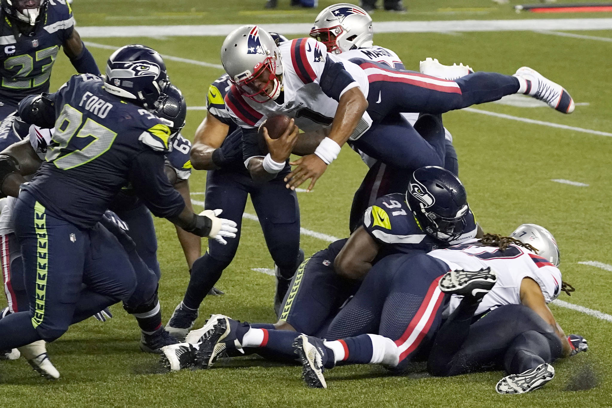 New England Patriots quarterback Cam Newton dives with the ball, but is stopped near the goal line as the clock expires in the fourth quarter of an NFL football game against the Seattle Seahawks last Sunday at CenturyLink Field. The Seahawks won 35-30. (AP Photo/Elaine Thompson)