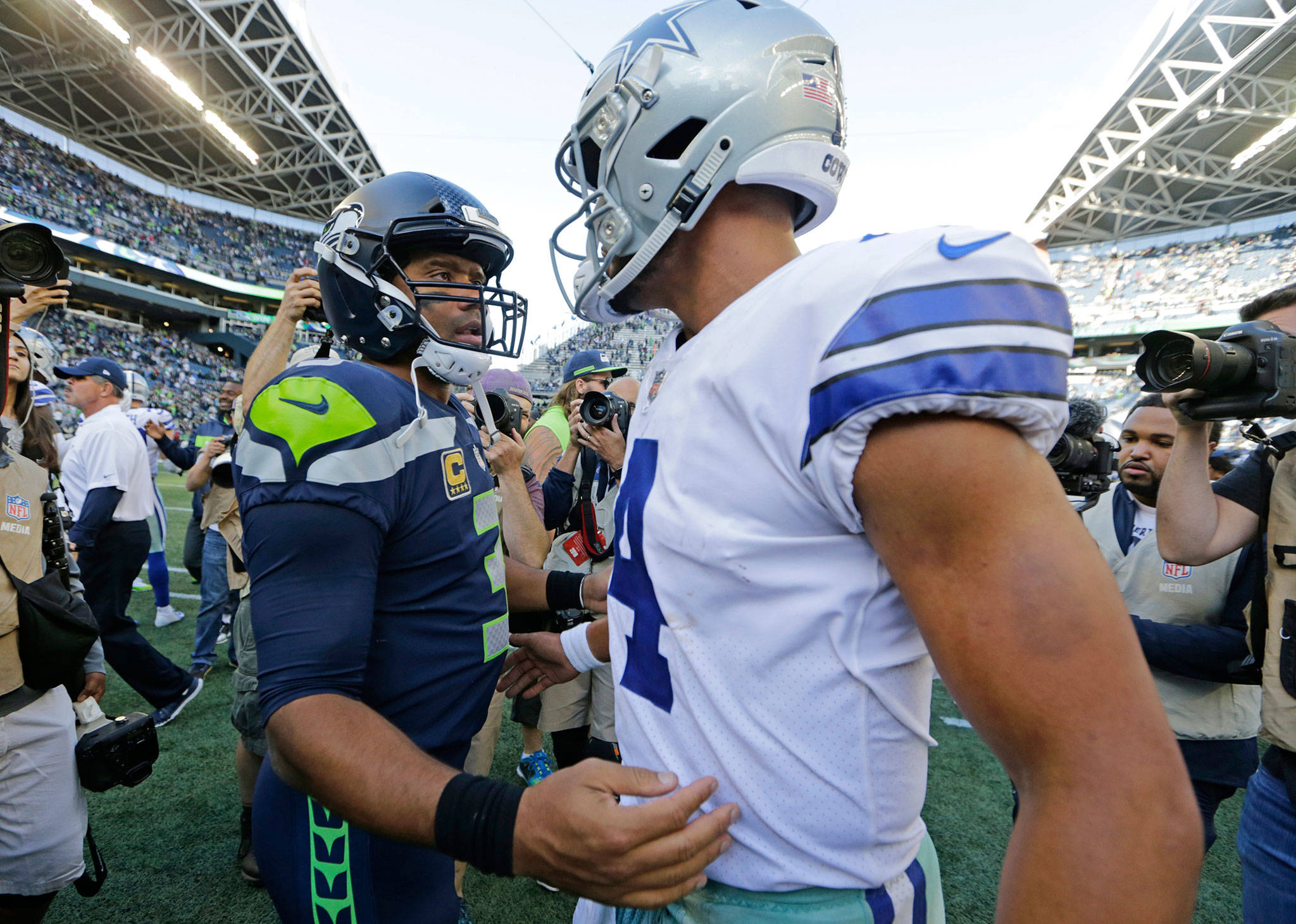 Seahawks quarterback Russell Wilson (left) greets Cowboys quarterback Dak Prescott (right) following a game on Sept. 23, 2018, in Seattle. (AP Photo/John Froschauer)