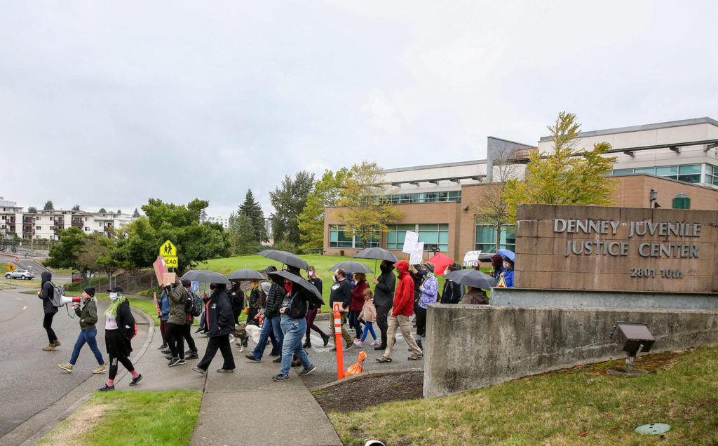 Protesters march to push reforms Saturday outside Denney Juvenile Justice Center in Everett. (Kevin Clark / The Herald)
