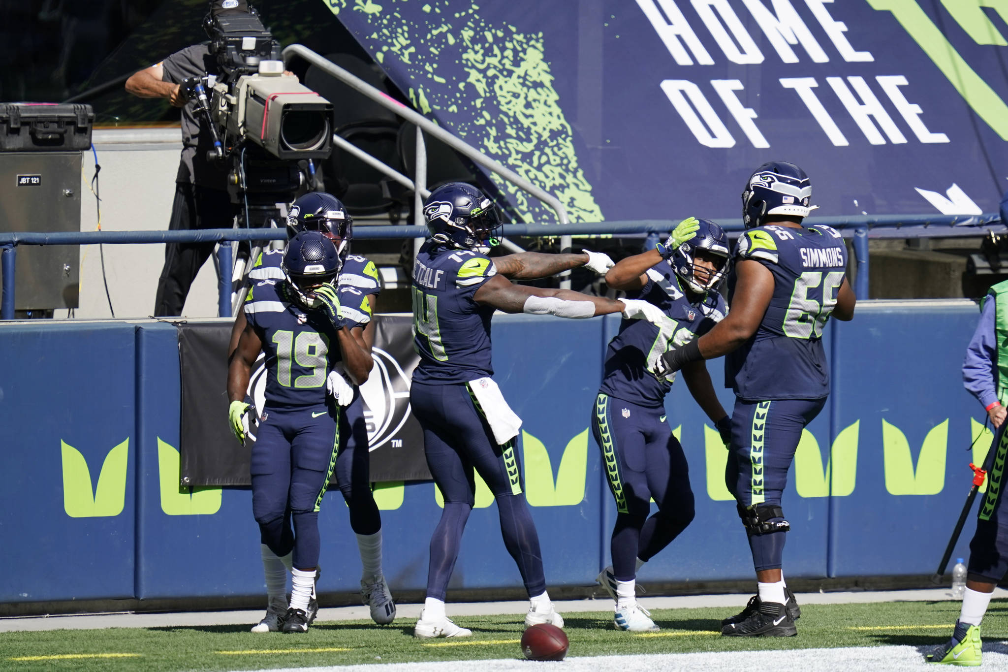 Seattle Seahawks receiver Tyler Lockett, second from right, celebrates with teammates DK Metcalf, center, and Jordan Simmons, right, after Lockett scored a touchdown against the Dallas Cowboys during the first half of Seattle’s 38-31 victory Sunday at CenturyLink Field. (AP Photo/Elaine Thompson)