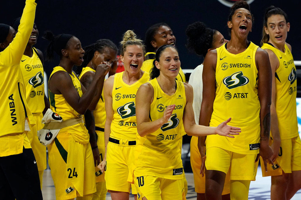 The Seattle Storm celebrate Sunday after the team defeated the Minnesota Lynx in Game 3 of a WNBA basketball semifinal round playoff series in Bradenton, Fla. The Storm move onto the WNBA finals. (AP Photo/Chris O’Meara)
