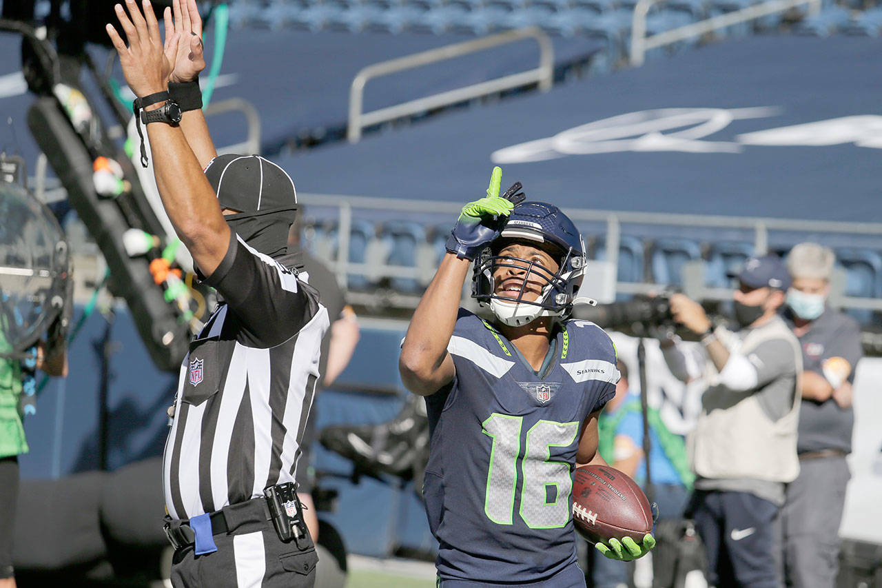 Seattle Seahawks wide receiver Tyler Lockett reacts after scoring a touchdown against the Dallas Cowboys on Sept. 27. (John Froschauer / Associated Press)