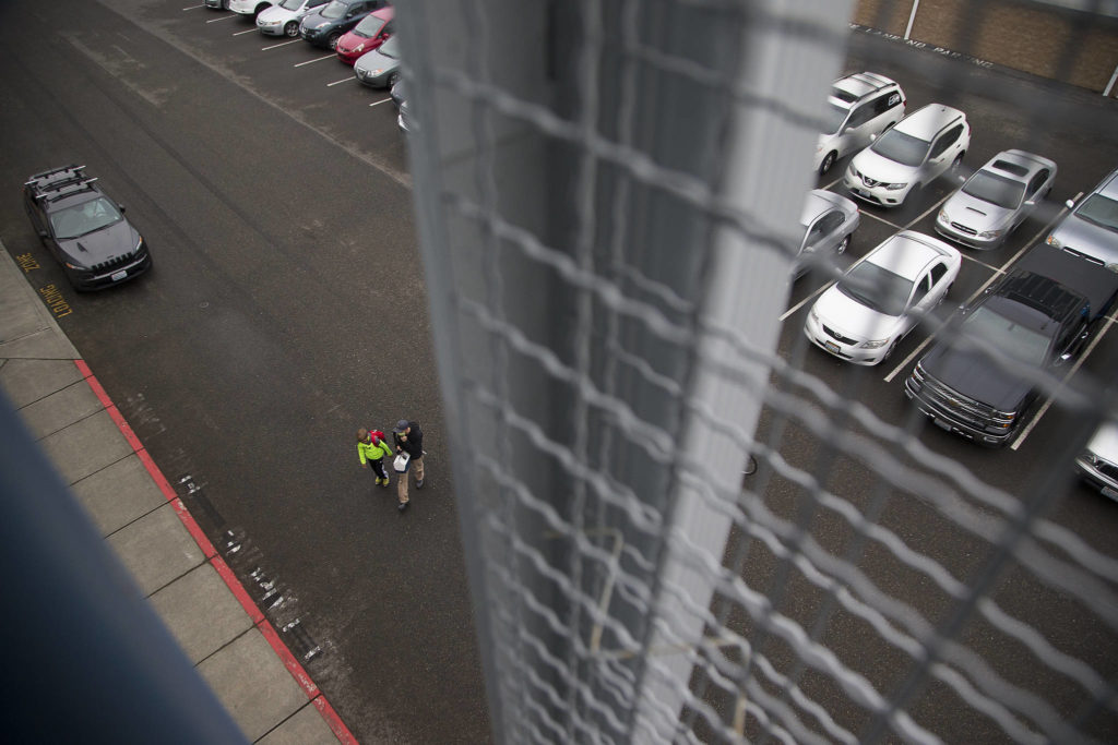 An employee and son head for the stairs at Electroimpact. (Andy Bronson / The Herald)
