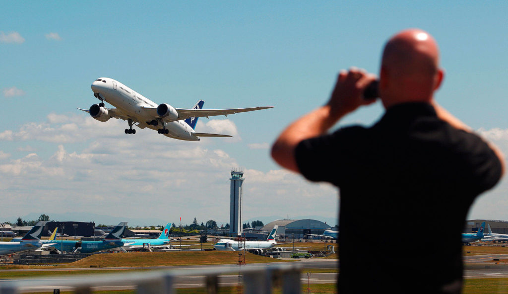 Mark Mulligan / Herald file
Alan Evans, visiting the Future of Flight Museum from Manchester, England, photographs a Boeing 787 lifting off the runway at Paine Field from the museum’s observation deck on July 29, 2011.
