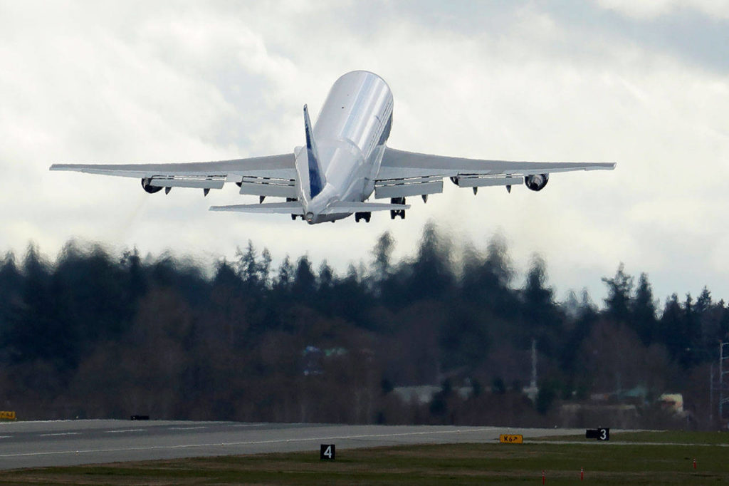 A Boeing Dreamlifter airplane takes off from Paine Field near Boeing’s manufacturing facility in Everett on March 23. (AP Photo/Ted S. Warren, file)
